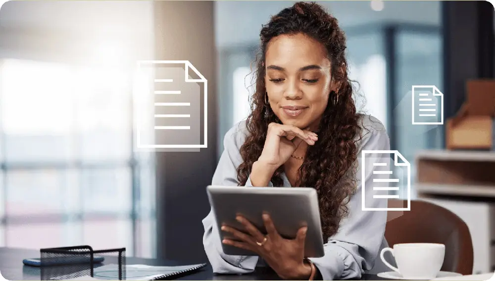 Convept image of female business person looking at tablet with generic document icons overlayed