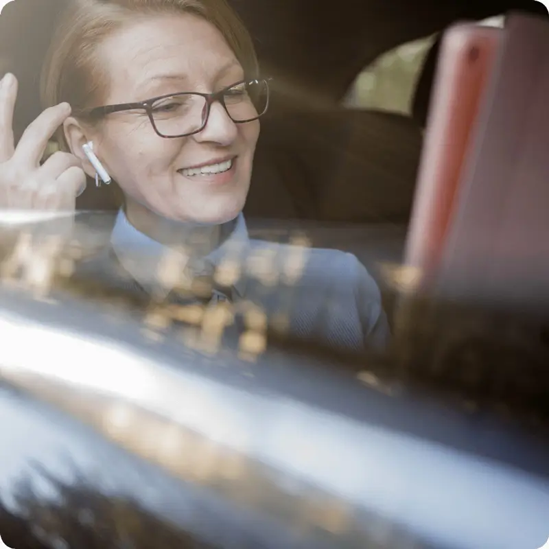 A person taking a virtual call from a car